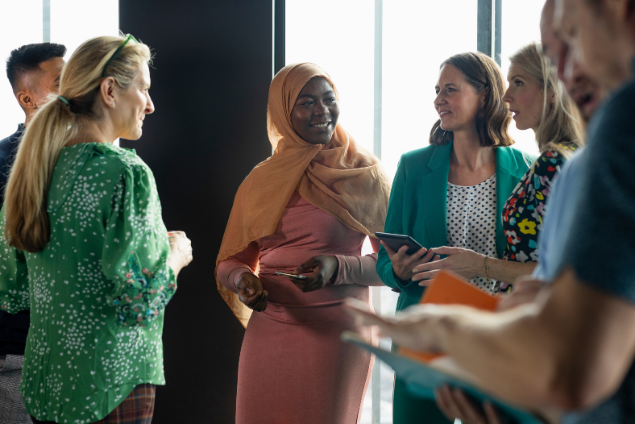 Colleagues from diverse backgrounds in conversation